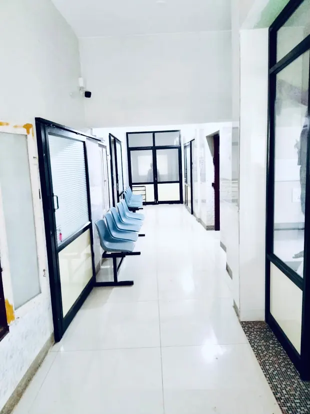 Corridor with consultation rooms and patient seating inside Pratheep Nursing Home